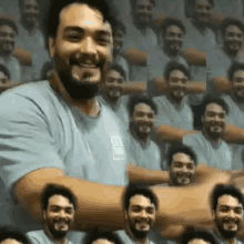 a man with a beard is standing in front of a bunch of people .