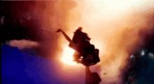 a person is flying through the air in front of a large explosion .