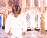 a blurry picture of a man dancing in front of a church