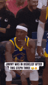 a golden state warriors basketball player sitting in the stands