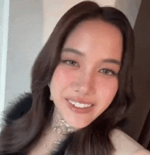 a close up of a woman 's face with a choker on her neck .