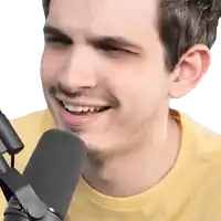 a man in a yellow shirt is smiling in front of a microphone that says ' o'reilly ' on it