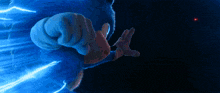 a sonic the hedgehog is flying through the air with a blue light behind him
