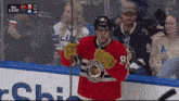 a hockey player wearing a jersey that says blackhawks