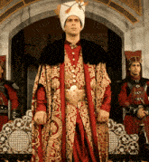 a man in a red and gold costume with a hat on