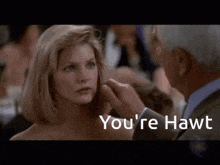 a man touching a woman 's face with the words " you 're hawt " below it