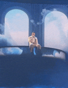 a man sitting on a couch with a microphone in front of him