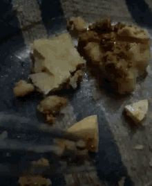 a plate of food with a fork and a piece of cheese on it