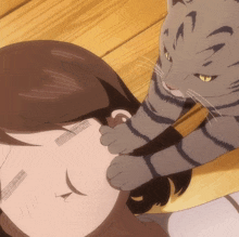 a cat is licking a woman 's face with its paw