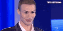 a man with a shaved head is making a funny face on a stage .