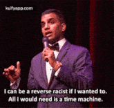 a man in a suit is holding a microphone and saying i can be a reverse racist