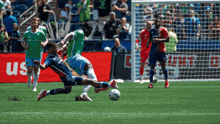 a soccer game is being played in front of a banner that says us bank