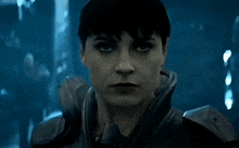 a close up of a woman 's face wearing a black jacket