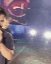 a blurry picture of a man holding a microphone in front of a large mouth