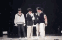 a group of people are standing on a stage and one of them is crying .