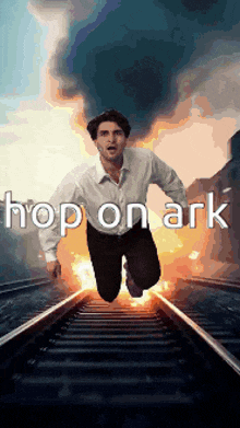 a man is jumping over train tracks with the words hop on ark written above him