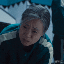 a close up of a woman 's face with the word netflix on the bottom right