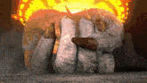 a close up of a person 's hands in front of a fire