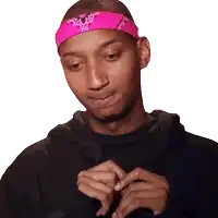 a man with a pink bandana on his head looks down