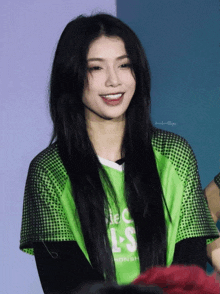 a woman wearing a green shirt that says ls