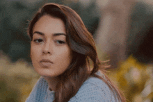 a close up of a woman 's face with a blurry background
