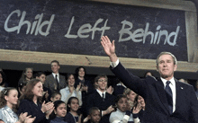 a man in front of a sign that says child left behind