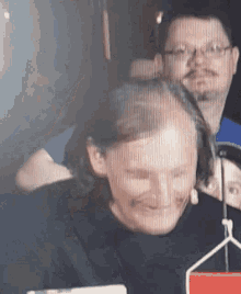 a man is cutting a woman 's hair with a comb