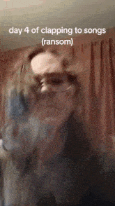 a woman wearing glasses is clapping to a song with the caption day 4 of clapping to songs ( ransom )