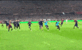 a group of soccer players are playing soccer on a field .