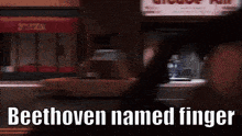 beethoven named finger is written on a sign outside of a restaurant