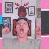 a man wearing a hat with a reindeer on top of it