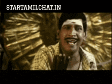 a man with a mustache is smiling in front of a starttamilchat.in logo