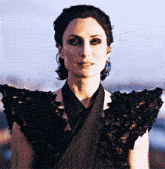 a woman wearing a black dress with a ruffled collar