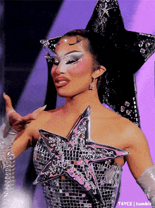 a woman is wearing a star shaped top and gloves and has a star on her head