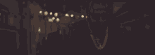 a man wearing sunglasses and a necklace is walking down a street at night .