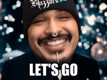 a man with a beard is smiling with the words let 's go on the bottom