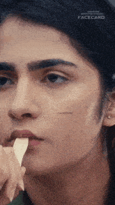 a close up of a woman 's face with facecard written on her face
