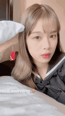 a girl is laying on a bed with the words good morning written on the bottom