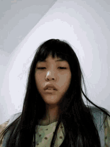 a close up of a girl 's face with her eyes closed and her mouth open