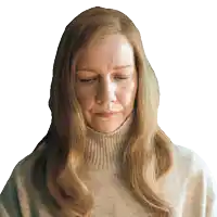 a woman with long blonde hair wearing a turtleneck sweater looks down with her eyes closed