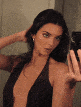 a woman is taking a picture of herself in the mirror