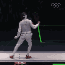 a man in a fencing uniform with els on the back