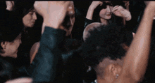 a group of people are dancing in a dark room