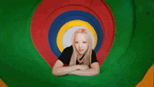 a woman is laying on her stomach in a colorful tube .