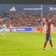 a soccer player wearing a red jersey with the number 11 on it