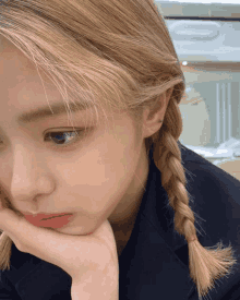 a close up of a woman 's face with braids