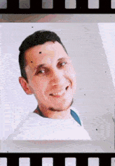a man with a beard is smiling in a film strip frame