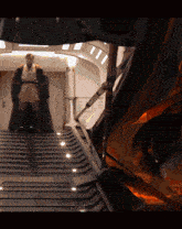 a man in a robe is standing on a set of stairs with the word chimetales on the bottom right