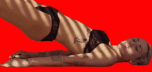 a woman in black underwear is laying on her back with her eyes closed