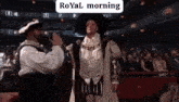 a man in a costume is standing in front of a crowd in a theater .